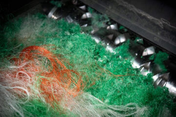View inside a shredder shredding green fishing nets