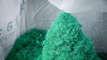 Green shredded fishing nets in a big bag