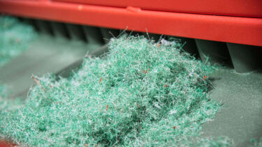 Shredded nylon fishing net on a conveyor belt
