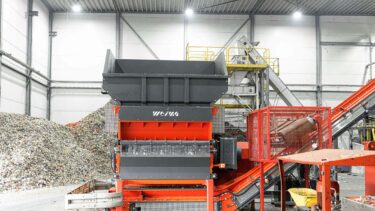 an orange WEIMA shredder W5.18 at a plastics recycler in the Netherlands