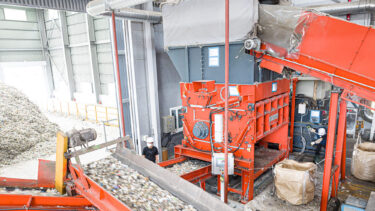 orange shredder shredding municipal waste at a recycling company in South Korea