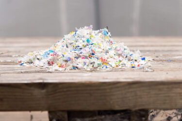 Auf einem Tisch liegen zerkleinerte, saubere, bunte Flakes
