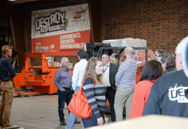 A group of recycling committee members tour the shop at WEIMA.