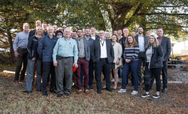 The Sustainability & Recycling Committee poses with some WEIMA employees for a group photo in the beer garden.