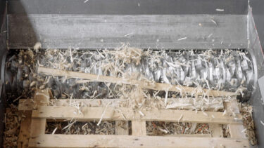 A pallet is shredded in the shredder.