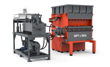 Power Pack of a hydraulic drive from Hägglunds next to an orange WEIMA shredder
