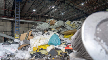 A large pile of industrial waste in a warehouse