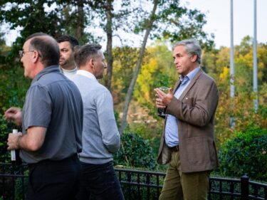 Man talking to several people at a party