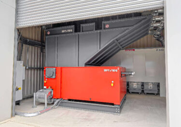 a orange WEIMA WL20 shredder in a small hall, with an dust extractor behind