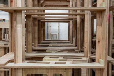 Assembled furniture is organized neatly in a warehouse.