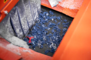 Textiles after shredding on a conveyor belt